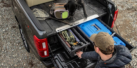Man wearing cap using DECKED ute sliding drawers to protect his tools